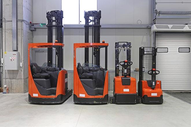 warehouse workers using forklifts